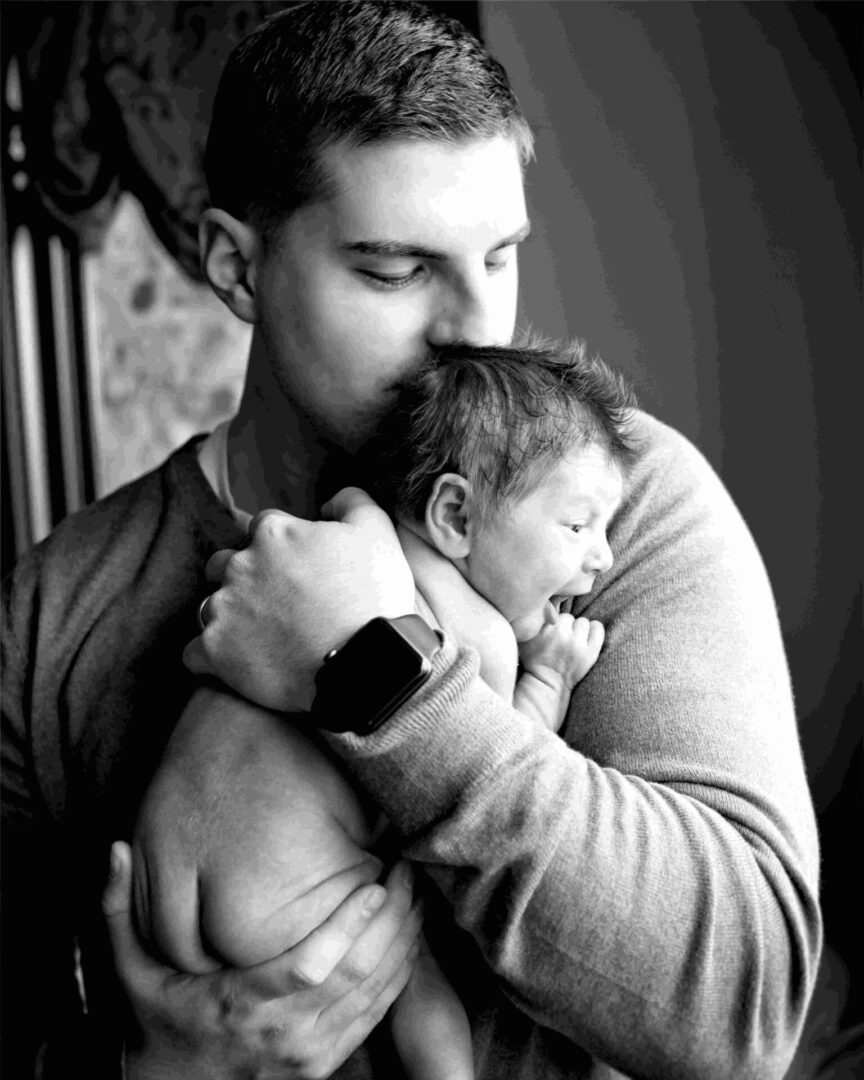 A man kissing a child's head